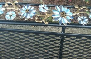 hand painted accent flowers on black bench