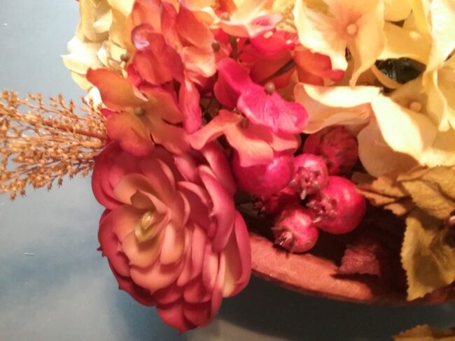 faux flowers, succulents and berries in a dough bowl