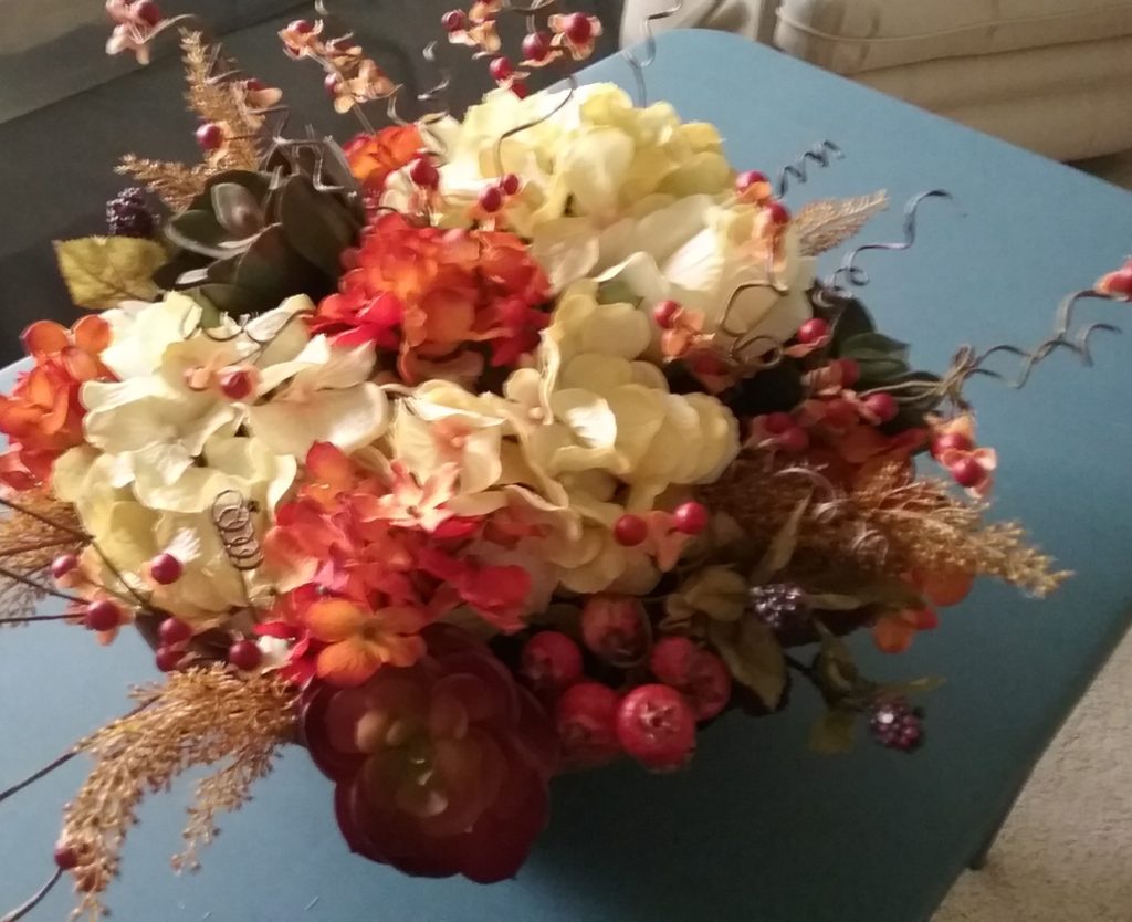 whimsical sprigs of bittersweet add autumn accents to the round dough bowl