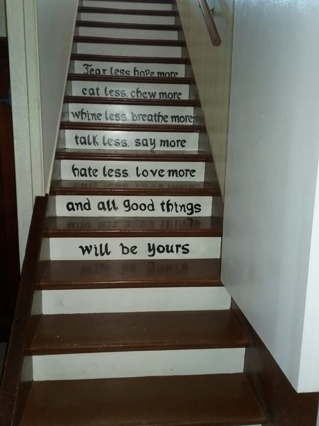 Inspirational words painted on the farmhouse staircase