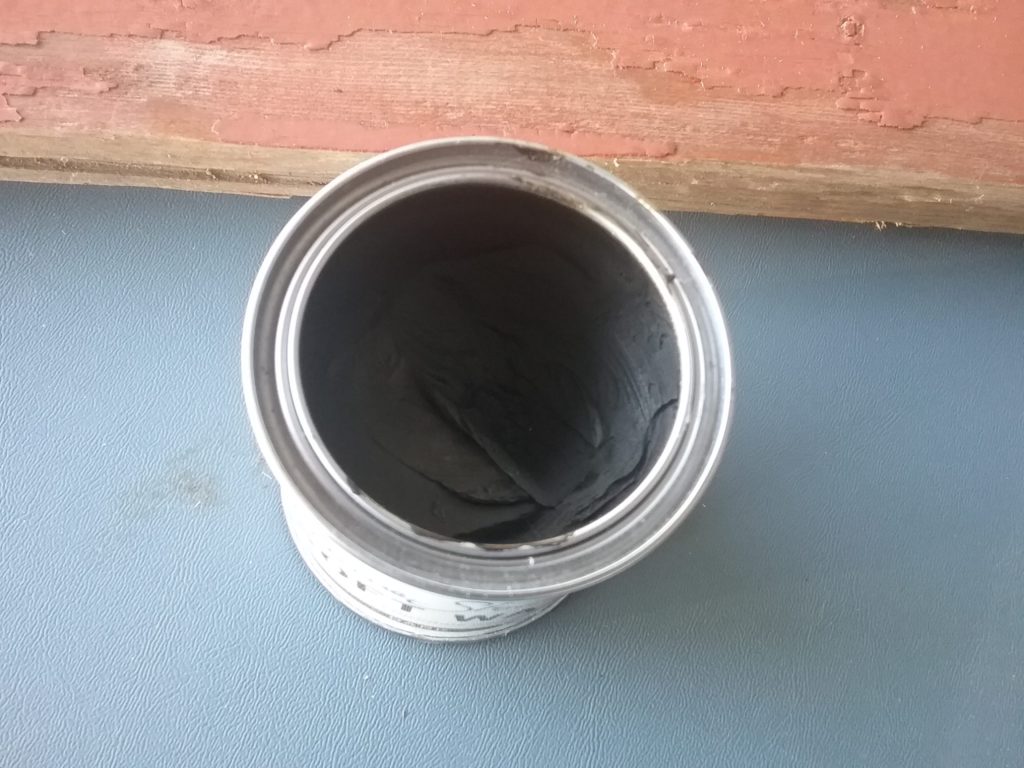 open can of dark wax