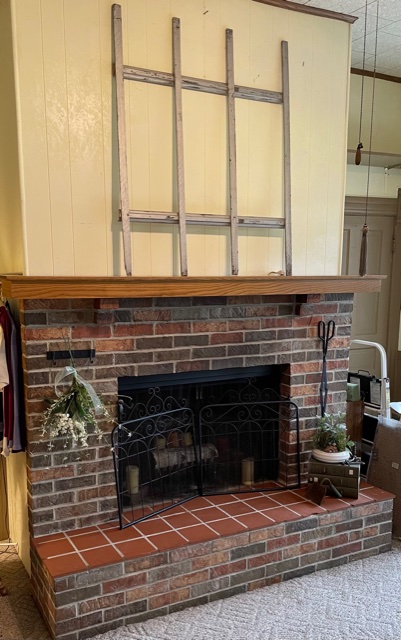 Farmhouse fireplace with garden gate on mantel