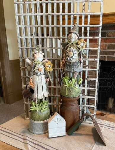 Garden Gnomes in front of wooden grate