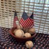 Dough bowl with flags & baseballs in front of wooden grate