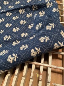 cream flowers on denim blue fabric