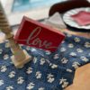 small red barnwood sign