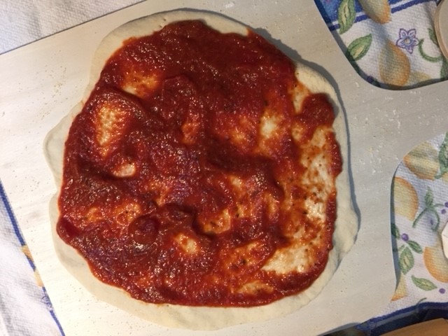 pizza dough sauced