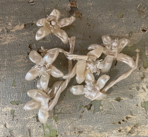 Vintage silk flowers circa 1948 laying on an old trunk