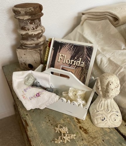 Shades of cream colored items gathered on an old trunk