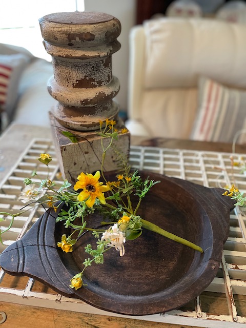 Black eyed susans on a wooden tray