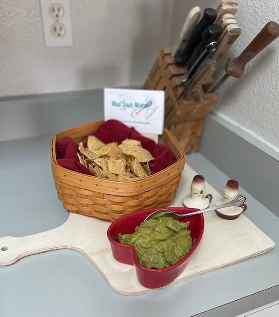 basket of chips with a dish of guacamole