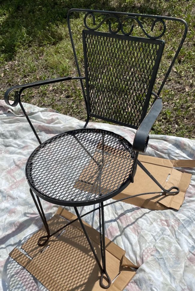 black wrought iron chair before being repainted