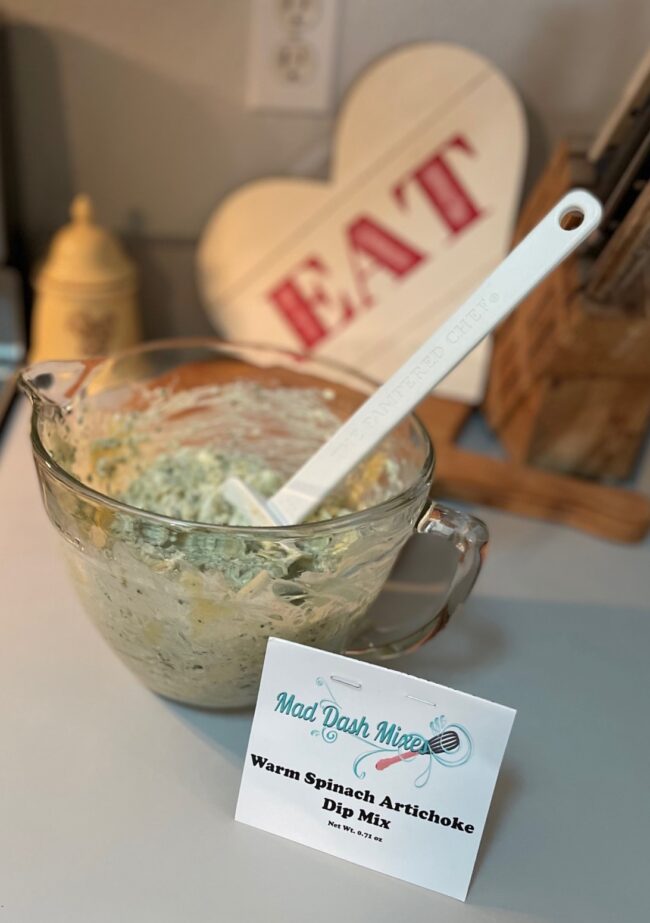 spinach artichoke dip mixed in a bowl