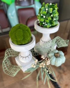 tallow berries and moss balls on wooden candle holders