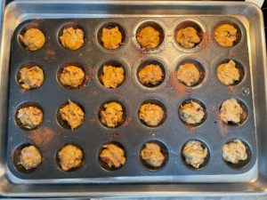 filled muffin tin ready to bake
