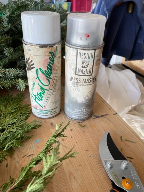 two spray cans of Design Master products that help remove evergreen resin