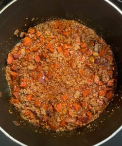 pot of ground beef, sausage & seasonings for Cincinnati Style chili