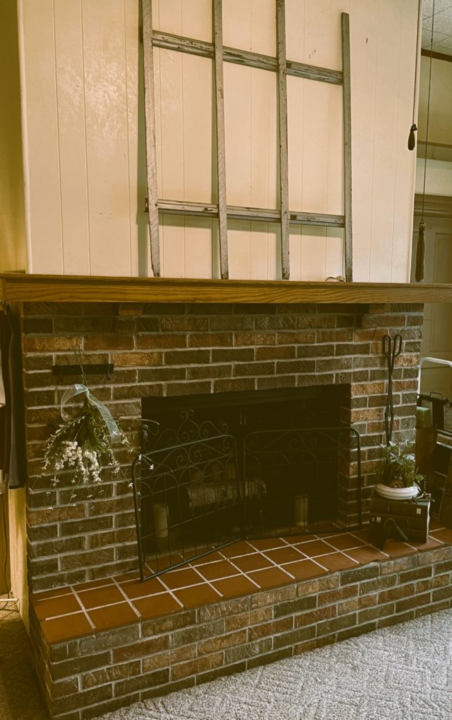 Brick fireplace with oak mantel