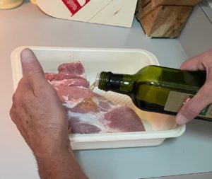 pouring olive oil on roast