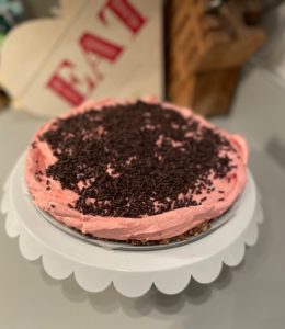 Chocolate sprinkles decorate the top of a Cherry Cheesecake