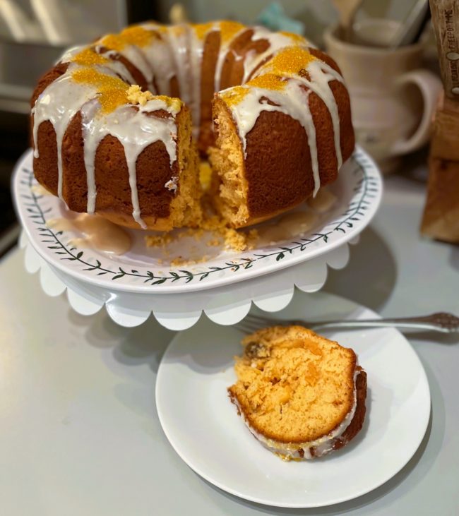 Orange Sunshine Cake with one slice out of it
