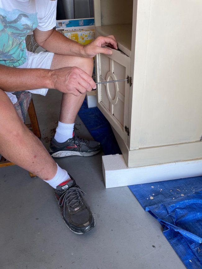 Dave putting doors on cabinet