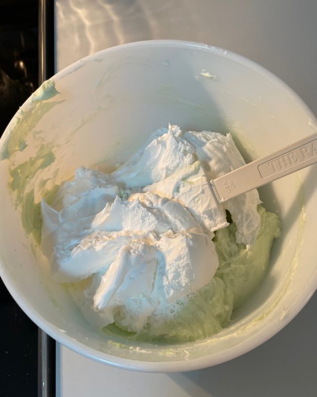 mixing bowl with whipped topping ready to fold