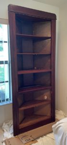 corner cabinet with doors off, damage to the back