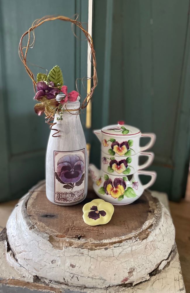 a trio of pansy themed decor items