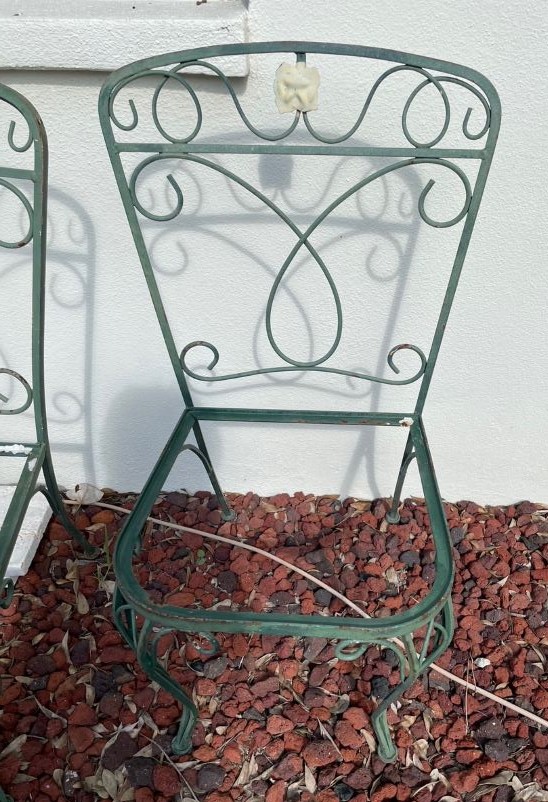 green wrought iron chair in need of refreshing