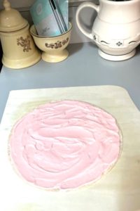 strawberry cheesecake filling spread on tortilla