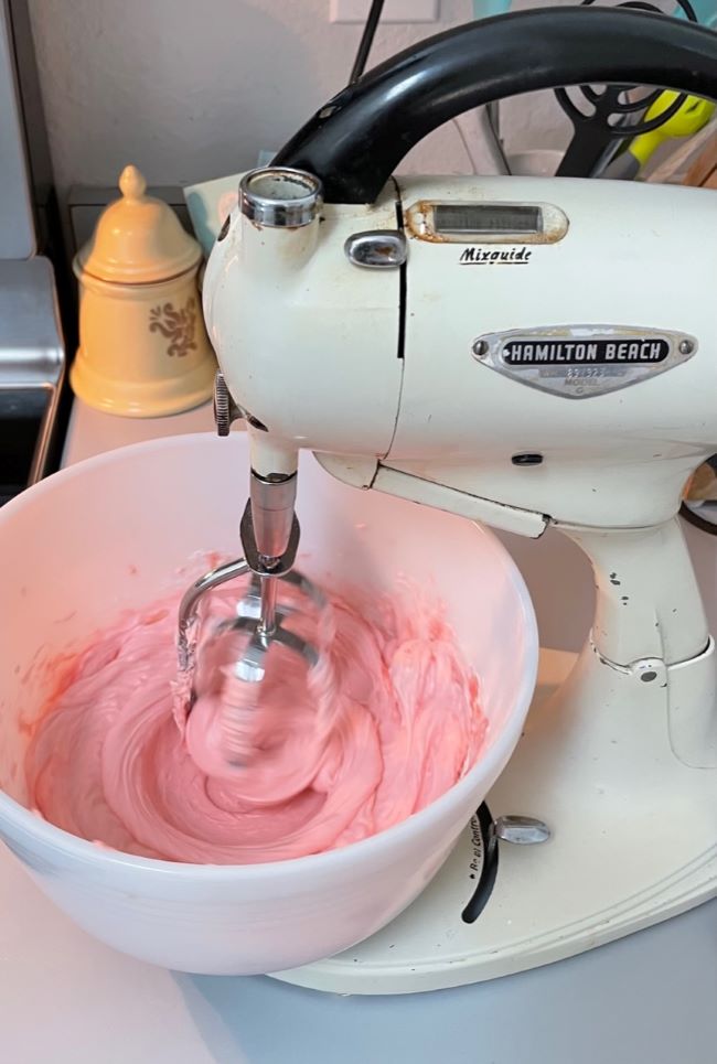 Mixing bowl with cream cheese and strawberry cheesecake mix