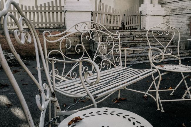 an antique wrought iron garden set