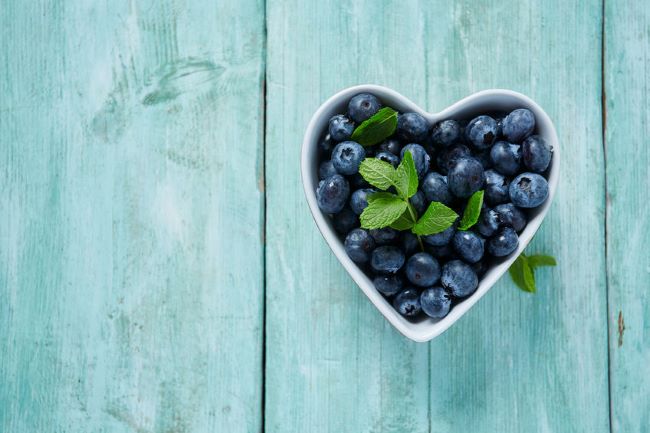 white heart shaped bowl of blueberries