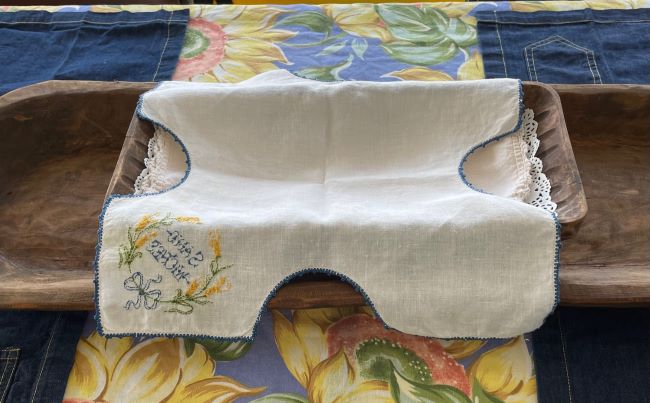 vintage linen placed in a rectangle dough bowl