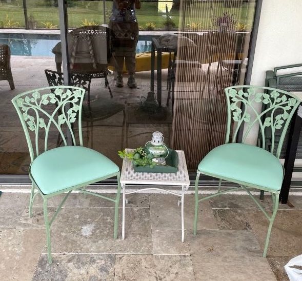pair of green garden chairs