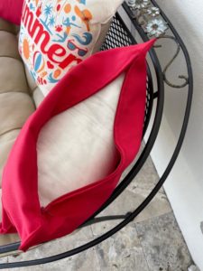 red pillow cover with zipper open, showing insert