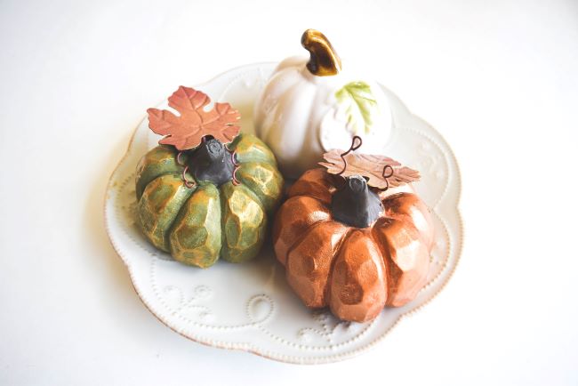 white plate with faux pumpkins