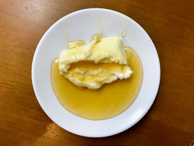 white plate with butter and honey on it