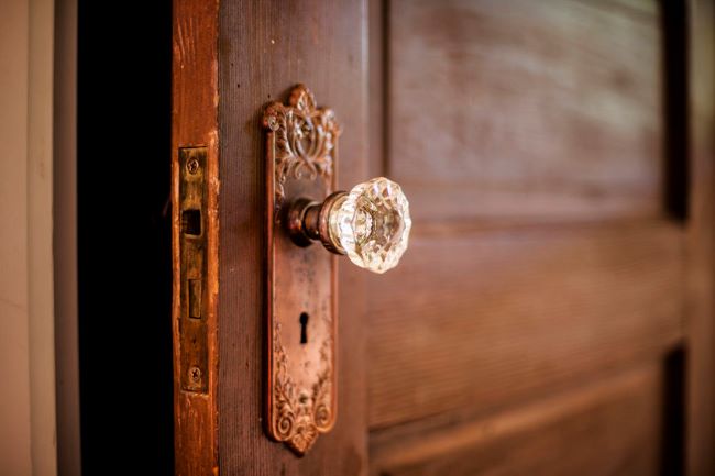 old wooden door with a glass door knob