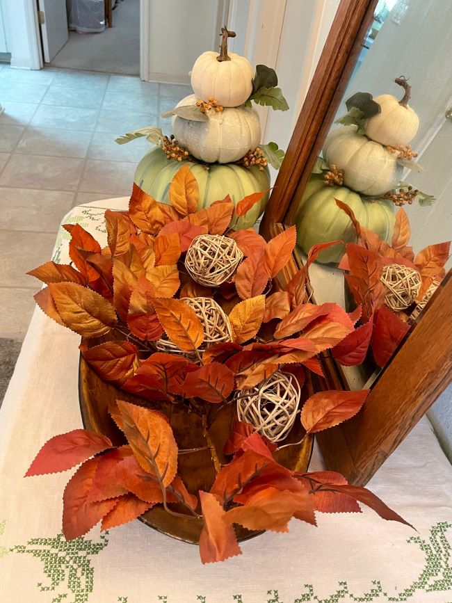 oval dough bowl with leaves & raffia twig balls