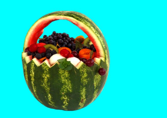 watermelon carved into a basket and filled with fruit salad