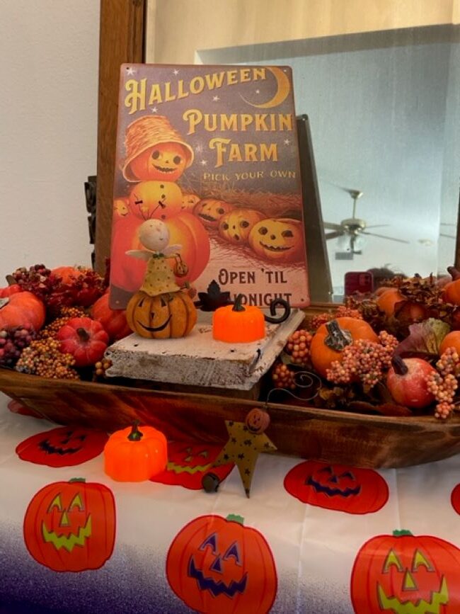Halloween sign with pumpkins and an Angel figurine
