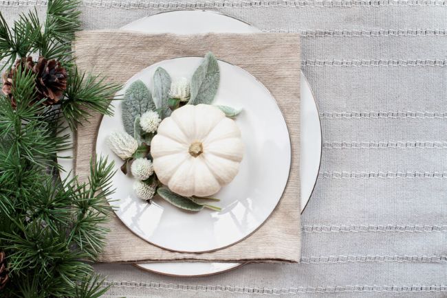 place setting of white plates with lamb's ear and white thistle accents