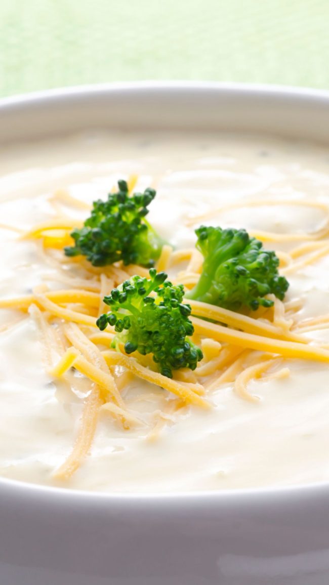 Cheese soup topped with cheese & broccoli