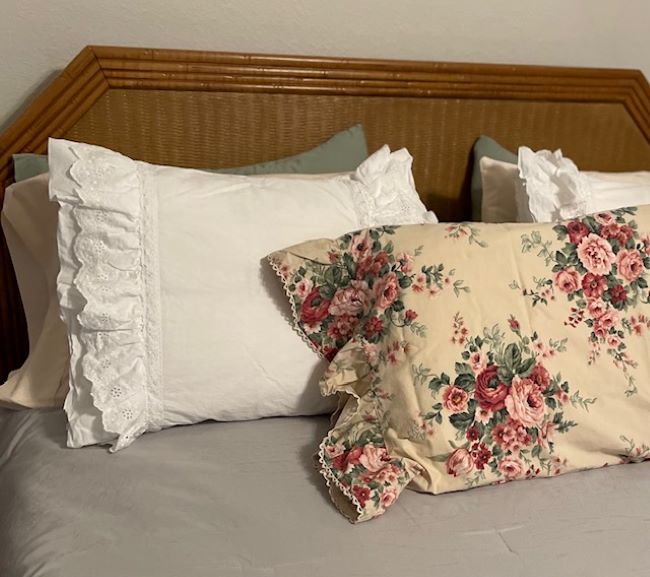 floral pillow case with a cream background trimmed with rick rack
