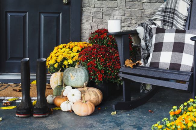 Vignette on front porch with a wooden rocking chair