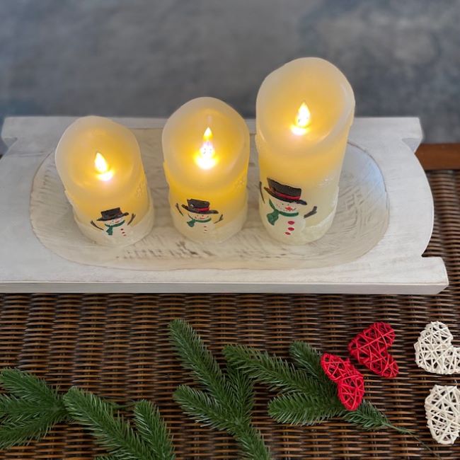 trio of battery operated snowman candles in white dough bowl