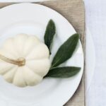 white pumpkin and lamb's ear on a white plate