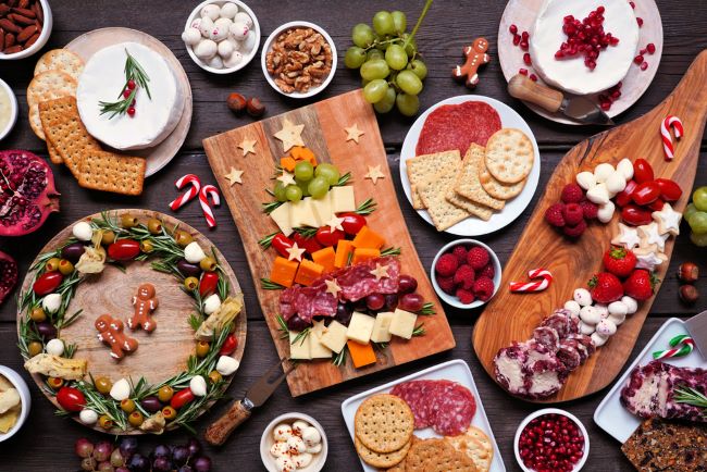 Assorted wooden charcuterie boards with Holiday snacks